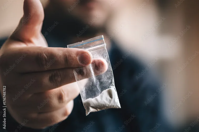 Drug dealer offers cocaine dose or another drugs in plastic bag, drug addiction on party concept